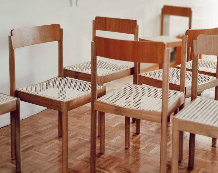 Minimalist classroom with wooden chairs and parquet flooring, perfect for educational themes.